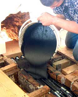 Pouring Structural Epoxy Resin into steel inside a shutter box.