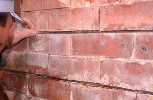 Putting a stitch of Epoxy Glass Bar into a brick mortar joint