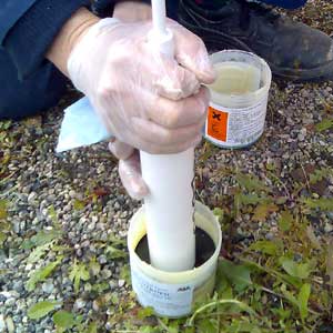 Grease pot pusher plate method of filling a cartridge tube